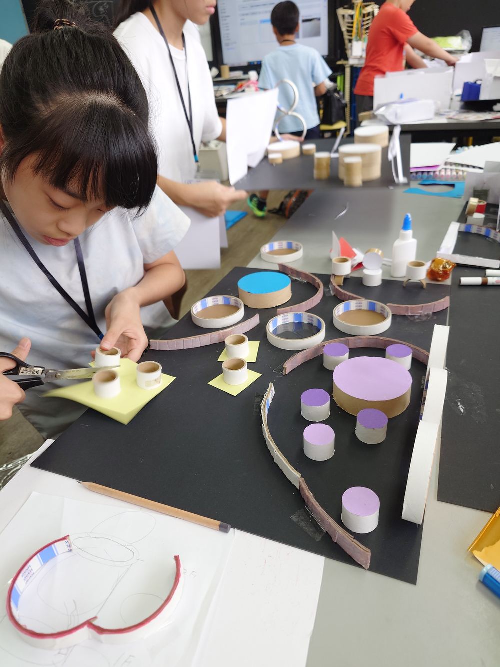 Children building models using tape cores